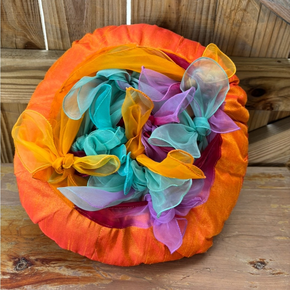 Pier 1 Round Orange Accent Pillow with Chiffon Scarves Tied on Top 14”